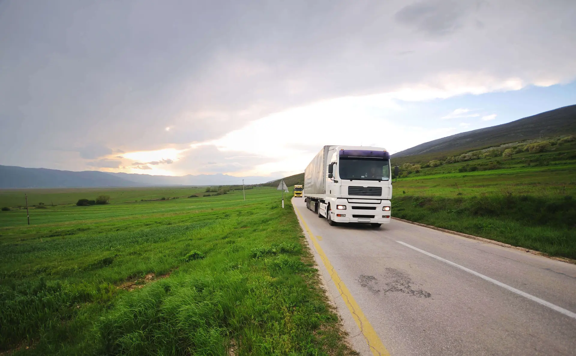 Truck traveling along a scenic road representing planned freight lanes